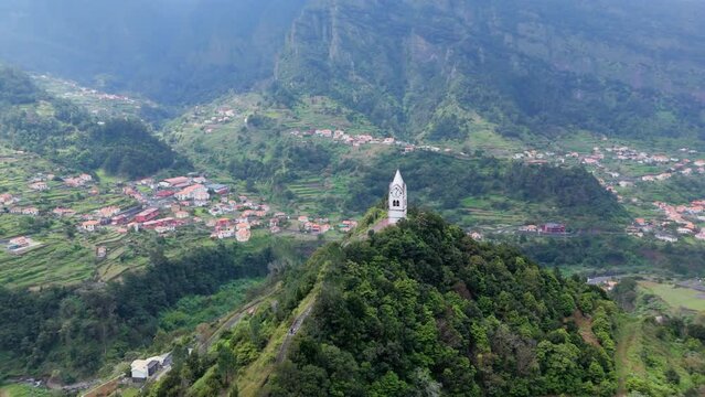 Flying around historic Clock Tower Of Chapel of Our Lady of Fatima on Madeira island, Portugal. Aerial orbit shot