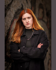 Portrait of a young beautiful red-haired girl in the studio.