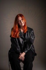 Portrait of a young beautiful red-haired girl in the studio.