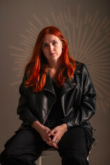 Portrait of a young beautiful red-haired girl in the studio.