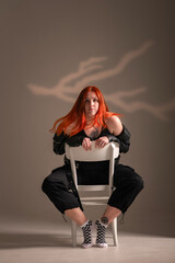 Portrait of a young beautiful red-haired girl in the studio.