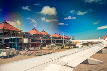 Bali, Indonesia - August 30, 2023: Airplanes along the Ngurah Rai International Airport runway in...