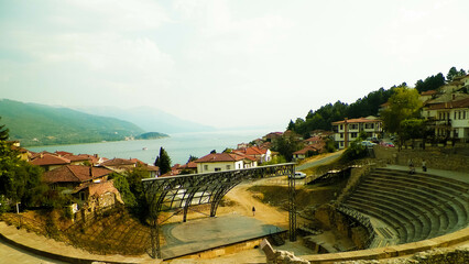 Old town in Ochrid City, amphitheater and water of Ochrid Lake as background. - obrazy, fototapety, plakaty