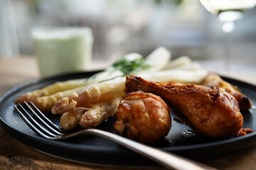 Fresh white asparagus with crispy chicken legs. Background for healthy eating concept with space...