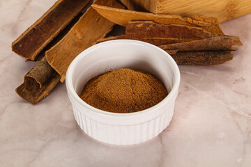 Natural Cinnamon powder with sticks - obrazy, fototapety, plakaty