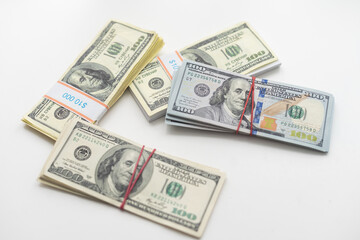 roles dollar notes in front of white background