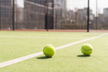 Bright greenish, yellow tennis ball on freshly painted court