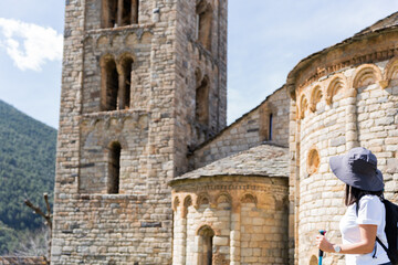 Female hiker making a pilgrimage through the Spanish Romanesque in the Catalan Pyrenees on a...