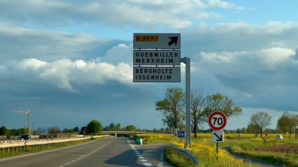 Navigational Directions at Dusk: D83 Road Sign with Cloudy Sky Near Guebwiller, Haut-Rhin, Alsace, France © Mickaël LEBRET