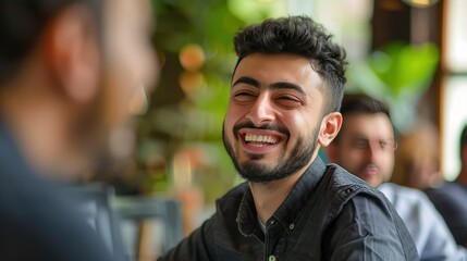 Close up view of the face of a young middle eastern Muslim man smiling kindly.