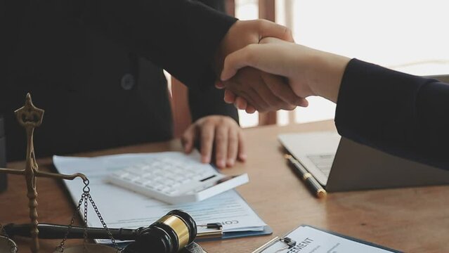Justice lawyer meeting with contract papers and Judge gavel on tabel in courtroom. Attorney working in courtroom. Justice and law, attorney, court judge concept.