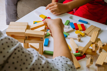 International Children Day. Beautiful Latino children playing with blocks on a white table....