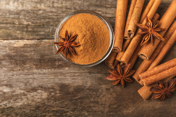 Cinnamon sticks and anise on a textured background. Cinnamon roll and star anise. Spicy spice for baking, desserts and drinks. Fragrant ground cinnamon.Place for text. copy space.