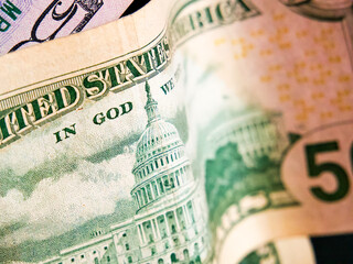 Financial Focus. Close-up of US dollars, Capitol building, and motto. Uses for Financial articles, economic education.