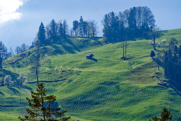Scenic rural landscape with meadows and ski lift seen from Swiss Bürgenstock mountain on a sunny...