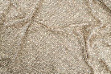 Texture draped beige jacquard fabric, top view, textured background.