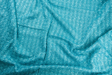 Texture of draped wool  light blue fabric with stripes, top view, textured background.