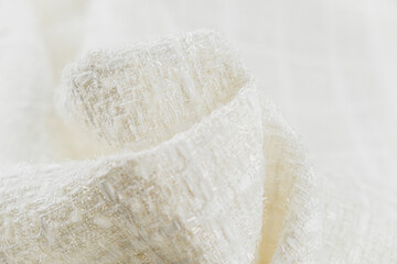 Close up of texture of draped wool white fabric, top view, textured background.