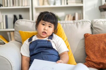 Portrait happy asian cute girl smiling face looking and think in bed, kid, child, young adorable, student, elementary school and education concept