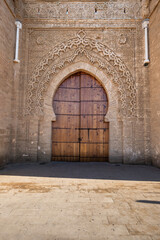 Fototapeta premium Wooden door of the main entrance gate to the fortified medieval necropolis of Chellah. located in Rabat, the capital of Morocco, is a historic and archaeological site of great significance