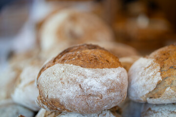 Bakery stall at medieval fair in France. Proud baker behind the counter.