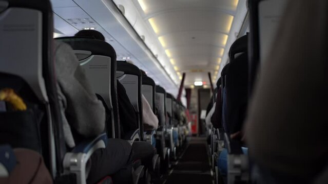 Video of flight in the plane. Unrecognisable passengers sitting in chairs on the plane. Footage can be used for your video.