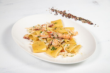 Paccheri allo scoglio is a italian food dish with pasta, seafood, shellfish and cherry tomatoes.