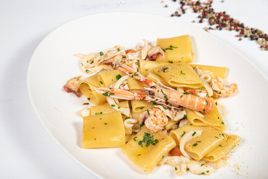 Paccheri allo scoglio is a italian food dish with pasta, seafood, shellfish and cherry tomatoes.
