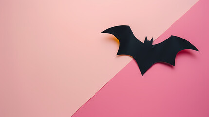 Fototapeta premium Paper Bat in Front of Pink Background: Halloween Concept with Copy Space