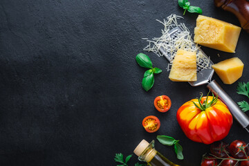 Set of Italian food cooking ingredients on a dark stone background with copy space top view. Healthy eating