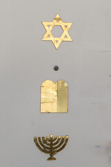 A doorway in Jerusalem, Israel, decorated with three symbols of the Jewish faith: a Star of David, tablets of the 10 commandments and a menorah.