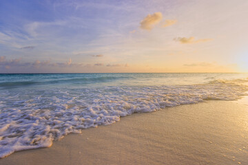 Closeup sea waves beach and colorful sunset sky. Summertime landscape. Empty tropical beach and...