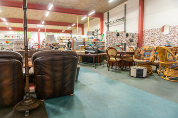 A big furniture store, second-hand. A lot of different furniture in the warehouse.