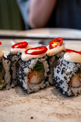 truffle sushi on a long plate in the restaurant in close-up