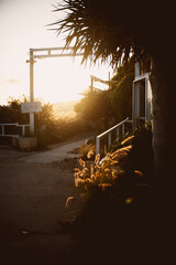 Beautiful sunset on a beach house, with a sign that says "LOVE".