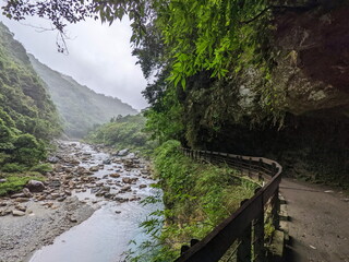 Taroko, Taiwan - 11.26.2022: Empty Shakadang Trail crawls along cliffs and trees with Liwu River...