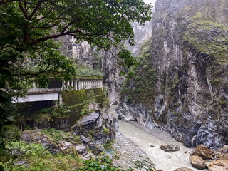 Taroko, Taiwan - 11.26.2022: Concrete pillars section of Swallow Grotto Trail along Liwu River and marble cliffs next to Chieftain Profile Rock on a rainy day before 403 earthquake during the pandemic