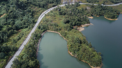 Fototapeta premium Green lake and rainforest tropical trees in Kuala Kubu Bharu, Malaysia.