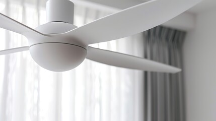 Modern ceiling fan with white blades in a softly lit room capturing the essence of contemporary design