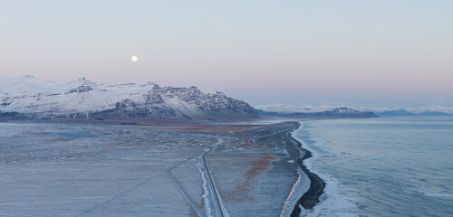 frozen winter view with sea and fullmoon