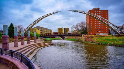 Sioux Falls City Skyline and Big Sioux Riverfront Trail Landscape with water reflections of the bridges in South Dakota, USA