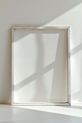 Empty white frame on a light background with shadows.