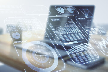 Double exposure of abstract creative statistics data hologram and modern desktop with laptop on background, statistics and analytics concept