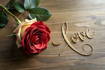 A red rose lies on the table. Greeting card or banner. Love.