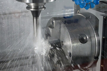 The 4-axis CNC milling machine  cutting the turbocharger part with liquid coolant method.