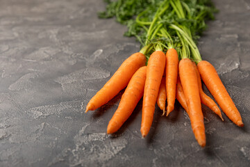 Carrots on a textured wooden background. Fresh and sweet organic carrots on a white background. Carrot slices. Vegan. Ingredients for salad. Place for text. Copy space. Flatley