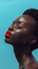 Skincare, lip gloss, and black woman with beauty, dermatology, and shine in blue studio. Individual or model with cosmetics, glow, or facial treatment for beauty, wellbeing, or health