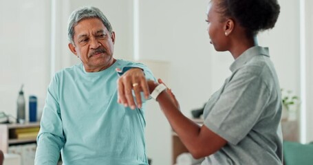 Pain, physiotherapy and senior man with doctor at hospital, clinic or wellness center for healing, appointment or health. Elderly person, medical worker or patient in office for healthcare consulting
