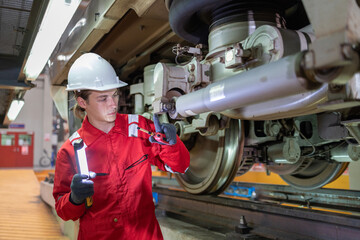 Technician Inspecting Train Suspension System