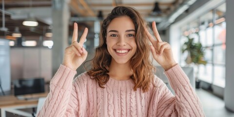 Peaceful, joyful, and motivated businesswoman with sign in workplace. Hispanic woman, girl, or hand gesture for solidarity, amusing or goofy for break, smiling and joyous with grin